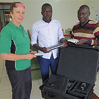 Asheri Stephen (extreme right), Entrepreneur for Rural Access (ERA) from Tanzania receiving the smart projector from Josephine Rodgers, Executive Director of Access Agriculture Asheri Stephen (extreme right), Entrepreneur for Rural Access (ERA) from Tanzania receiving the smart projector from Josephine Rodgers, Executive Director of Access Agriculture